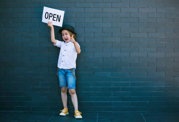 istock Happy boy with Open sign 1290584038