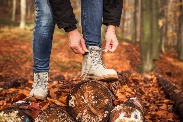 istock Hiker tying shoelace on her hiking boot 1290584950