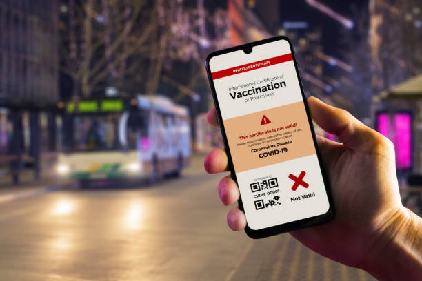 istock Smartphone displaying an invalid COVID-19 vaccination certificate in male's hand 1290586336