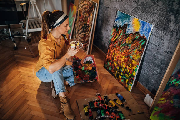 istock Female painter drinking coffee at her home atelier 1290587204
