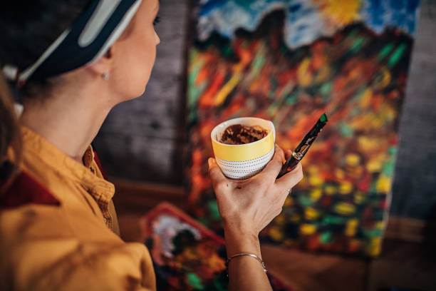 istock One female painter drinking coffee at her home atelier 1290587277
