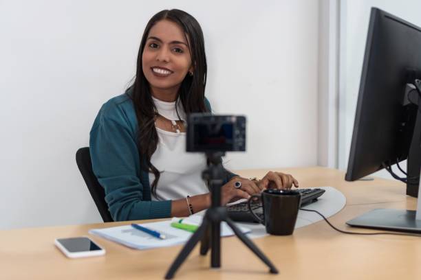 istock A smiling young Latina working on the computer sitting at a table in the studio 1290587883
