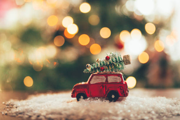 istock Decorated retro red car with festive New Year lights 1290594549