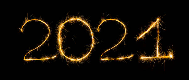 istock Happy New Year 2021 with sparklers on black background! 1290595502