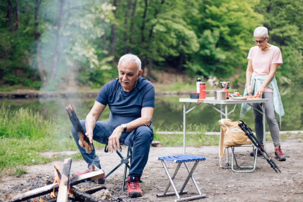 istock Happy seniors enjoying during camping by the river 1290597176