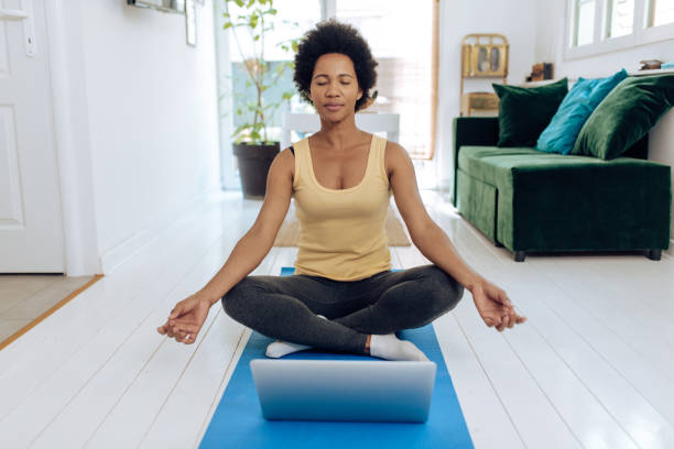 istock African-American woman practicing guided meditation online 1290597199
