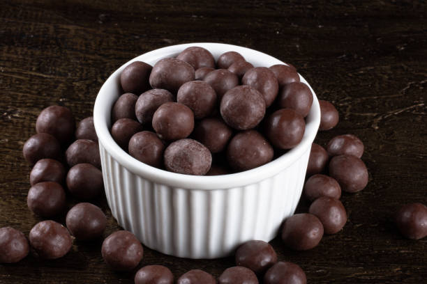 istock Chocolate balls in white bowl on rustic background. 1290598293
