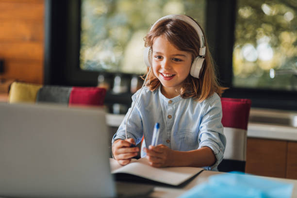 istock Schoolgirl studying at home 1290601087