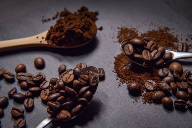 istock Three spoons with roasted coffee beans and ground coffee. 1290604162