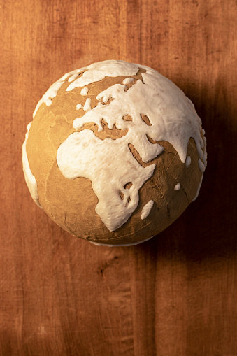 Paper Handmade globe of planet earth on wooden background showing Africa and Europe