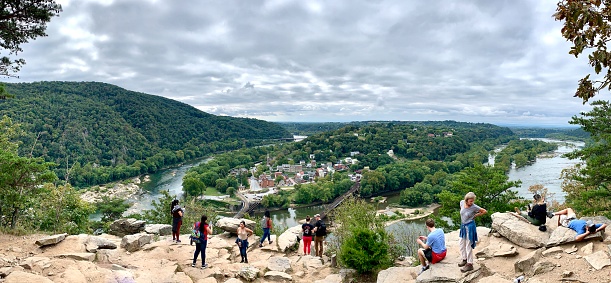 Harpers Ferry, Virginia, USA - September 26, 2020: High angle view of Harpers Ferry in Virginia, USA. Hikers visible in the foreground.