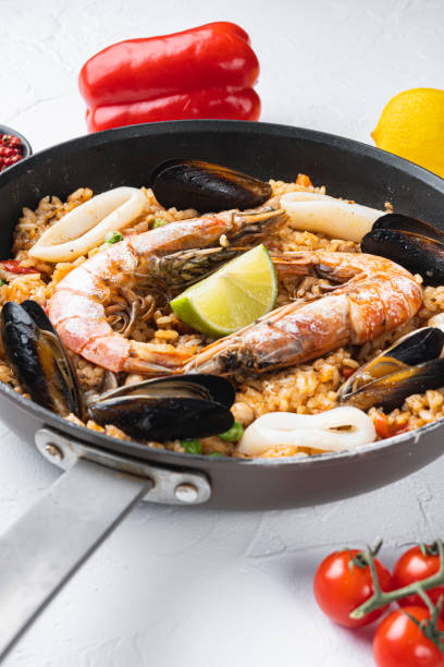 istock Paella with seafood and chicken on white background 1290615008