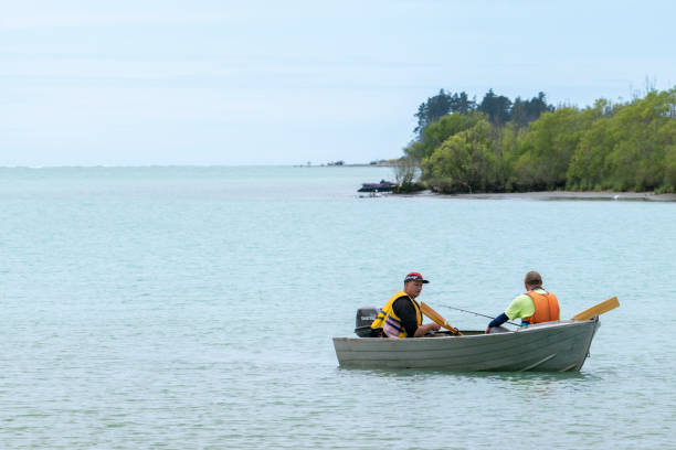 Free Stock Photo of Two People in a Small Boat on a Large Body of Water ...