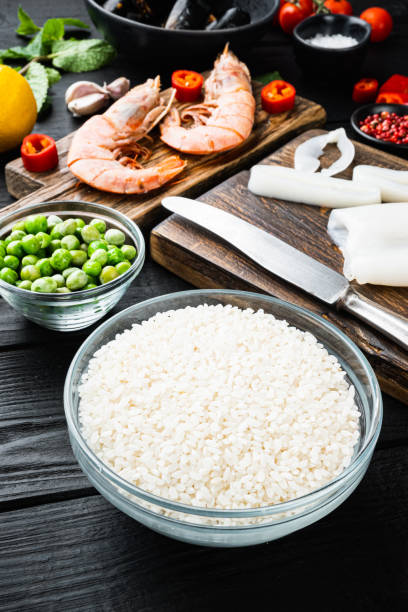 istock Raw paella ingredients over black wooden table 1290619414