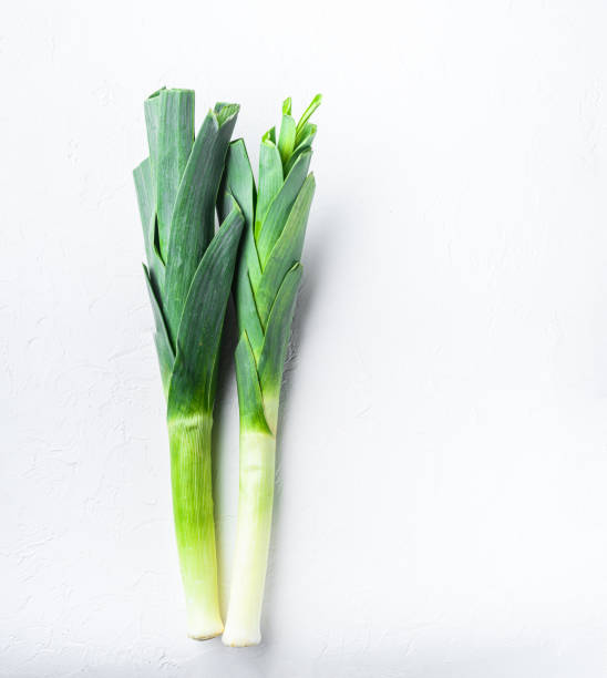 istock Green leek sultan onion on white table, top view. 1290620801