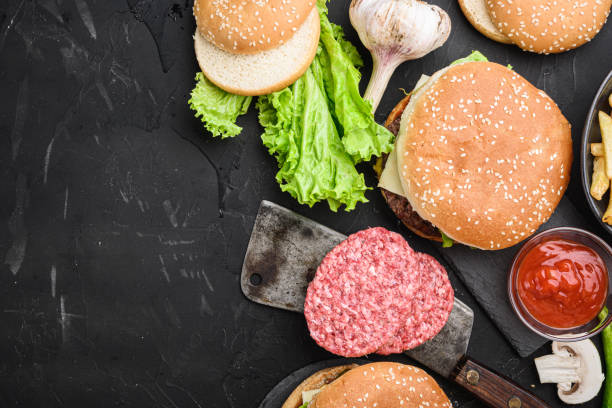 istock American burger ingredients on black textured background, topview with space for text 1290623700