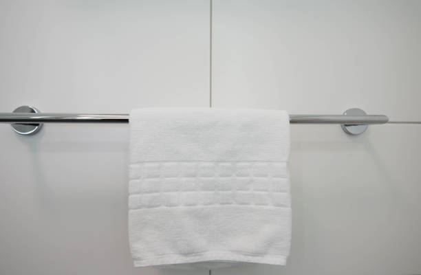 istock White towels hang on the bar in the bathroom 1290623730