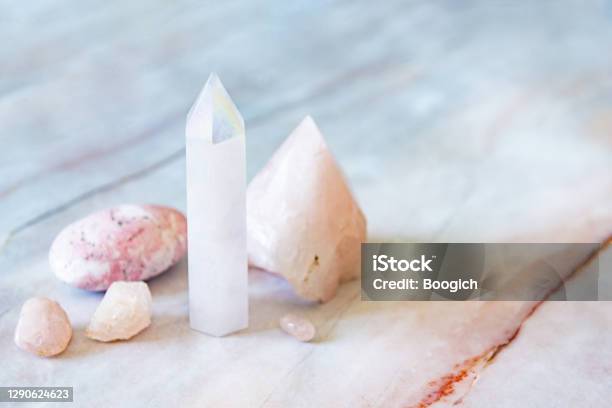 Rose And Angle Aura Quartz Crystals With Rhodonite Palm Stone Stock Photo - Download Image Now