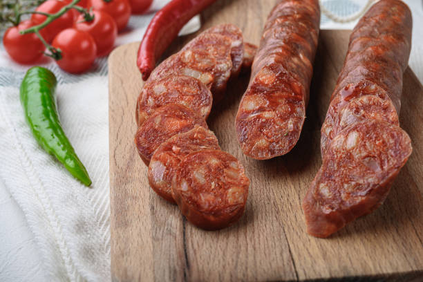 istock Traditional chorizo cuts with spices and ingredients on white surface 1290624638