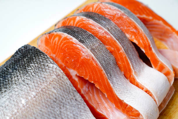 istock salmon sliced into pieces on a wooden cutting Board. red fish. 1290638009