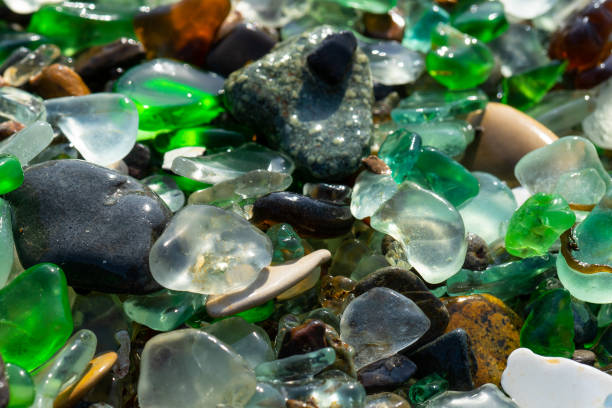 istock Natural background with sea glass close-up on sand. 1290638064