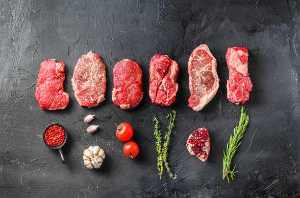 Variety of raw alternative steaks picanha, ramp and chuck eye roll and top blade with herbs for grill over black background top view. Big size. Space for text. Variety of raw alternative steaks picanha, ramp and chuck eye roll and top blade with herbs for grill over black background top view. Big size. Space for text boneless chuck steak stock pictures, royalty-free photos & images