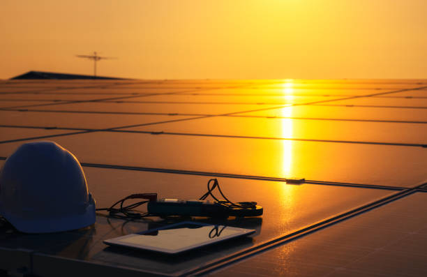 equipment tools with solar panels or solar cells on the roof of the house in the background sunset sky. - order repairing telephone change imagens e fotografias de stock