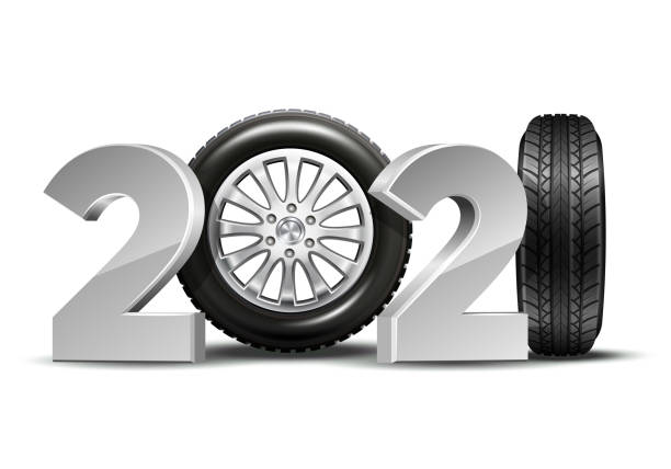 istock New Year numbers 2021 with car tire isolated on white background. 1290640110