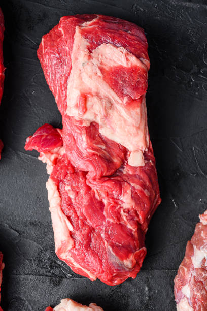 istock Organic chuck eye roll beef  steaks, top view on black textured table 1290644052