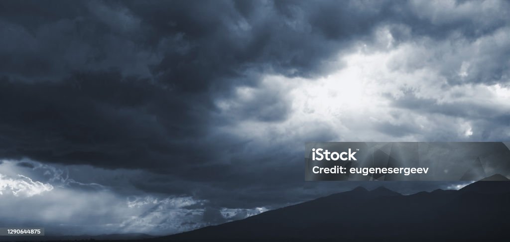 Dark blue dramatic sky with stormy clouds Dark blue dramatic sky with stormy clouds over mountains, natural panoramic background photo Abstract Stock Photo