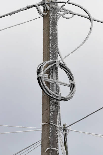 istock Ice crystal covered poles and wires 1290645850