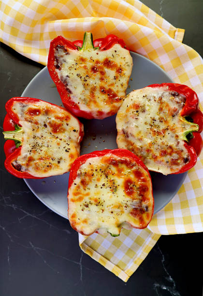 istock Plate of Fresh Cooked Delectable Homemade Stuffed Bell Peppers on Kitchen Table 1290645999