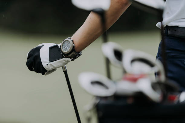 close up of golfer's hand with golf club at golf course golf golf glove stock pictures, royalty-free photos & images