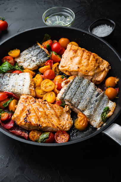 istock Smoky chorizosalmon grilled with cherry tomatoes on black background 1290647208