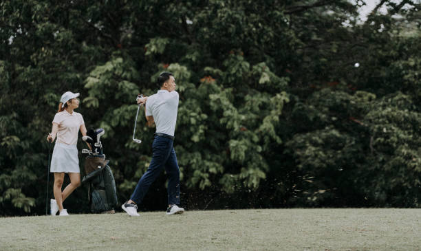 istock asian chinese mature man is teeing off at golf course while his friend is observing 1290647233