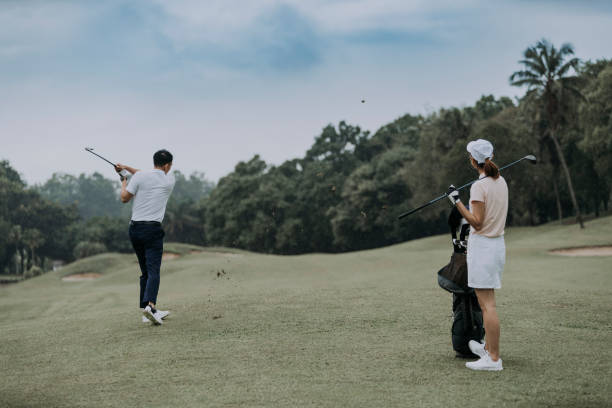 istock asian chinese mature man is teeing off at golf course while his friend is observing 1290647234