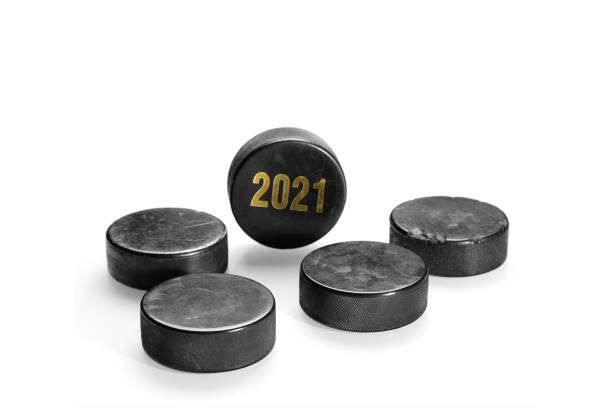 istock Hockey pucks on a white background 1290647510