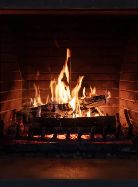 Photo of Fireplace, fire burning, cozy warm fireside, christmas home.