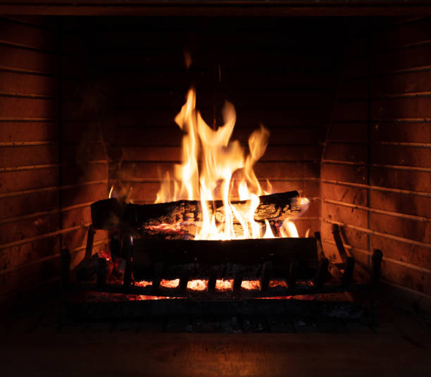 istock Fireplace, fire burning, cozy warm fireside, christmas home. 1290648227