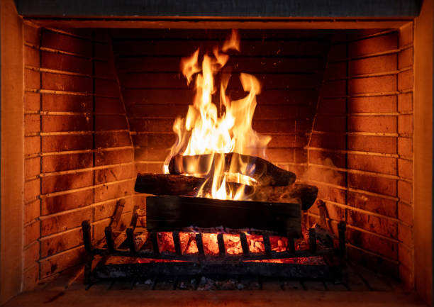 istock Fireplace, fire burning, cozy warm fireside, christmas home. 1290648242