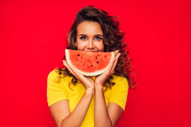 istock Smiling young woman holding watermelon 1290648854
