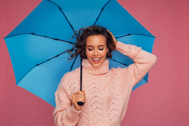 istock Girl with blue umbrella 1290648989