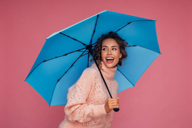 istock Girl with blue umbrella 1290649556