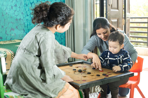 istock Mother with children playing carrom at home 1290649703
