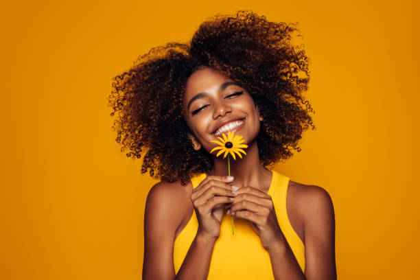 istock Beautiful afro woman with a flower 1290649712
