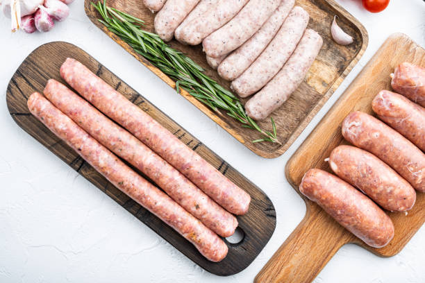 istock Assorted raw homemade sausages, flat lay, on white background 1290649791