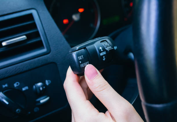istock Woman is pressing buttons in the car while driving. 1290650317