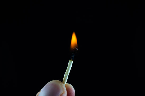istock Burning match in a man's hand. New idea concept. 1290651048