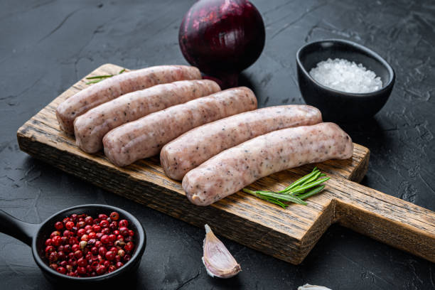 istock Homemade chicken sausages, on black background 1290653915