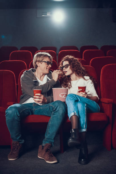 istock Young people are feeding each other popcorn in cinema. 1290653974